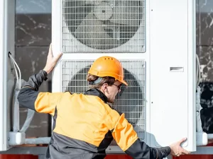 Technician installing a residential heat pump in Tennessee